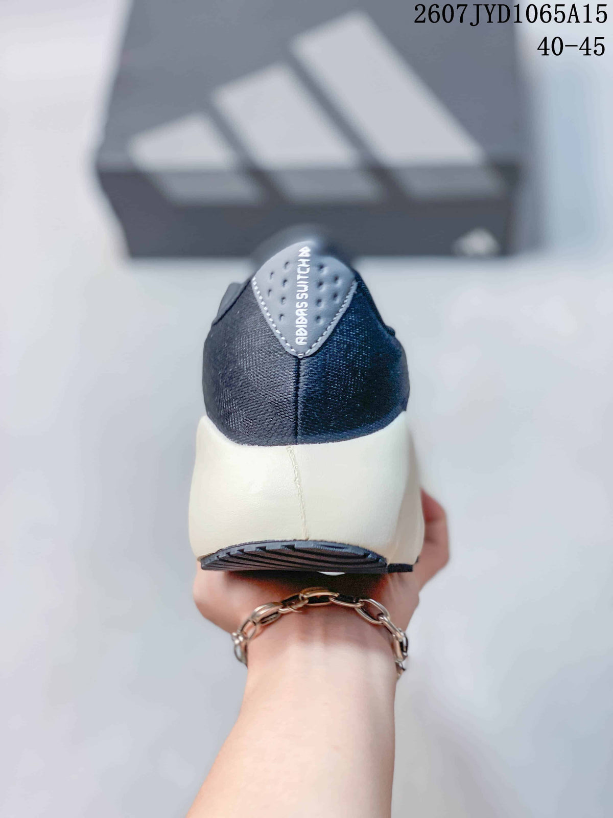 Rear view of the sneaker showing the dark textile-looking heel, padded collar and light-colored midsole.