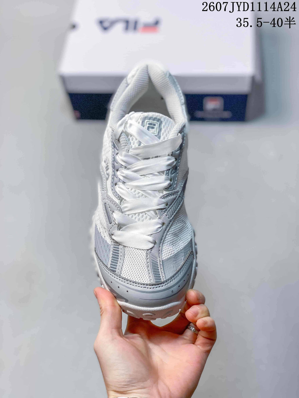 Top view showing the white satin-style laces, tongue branding, and layered toe design.