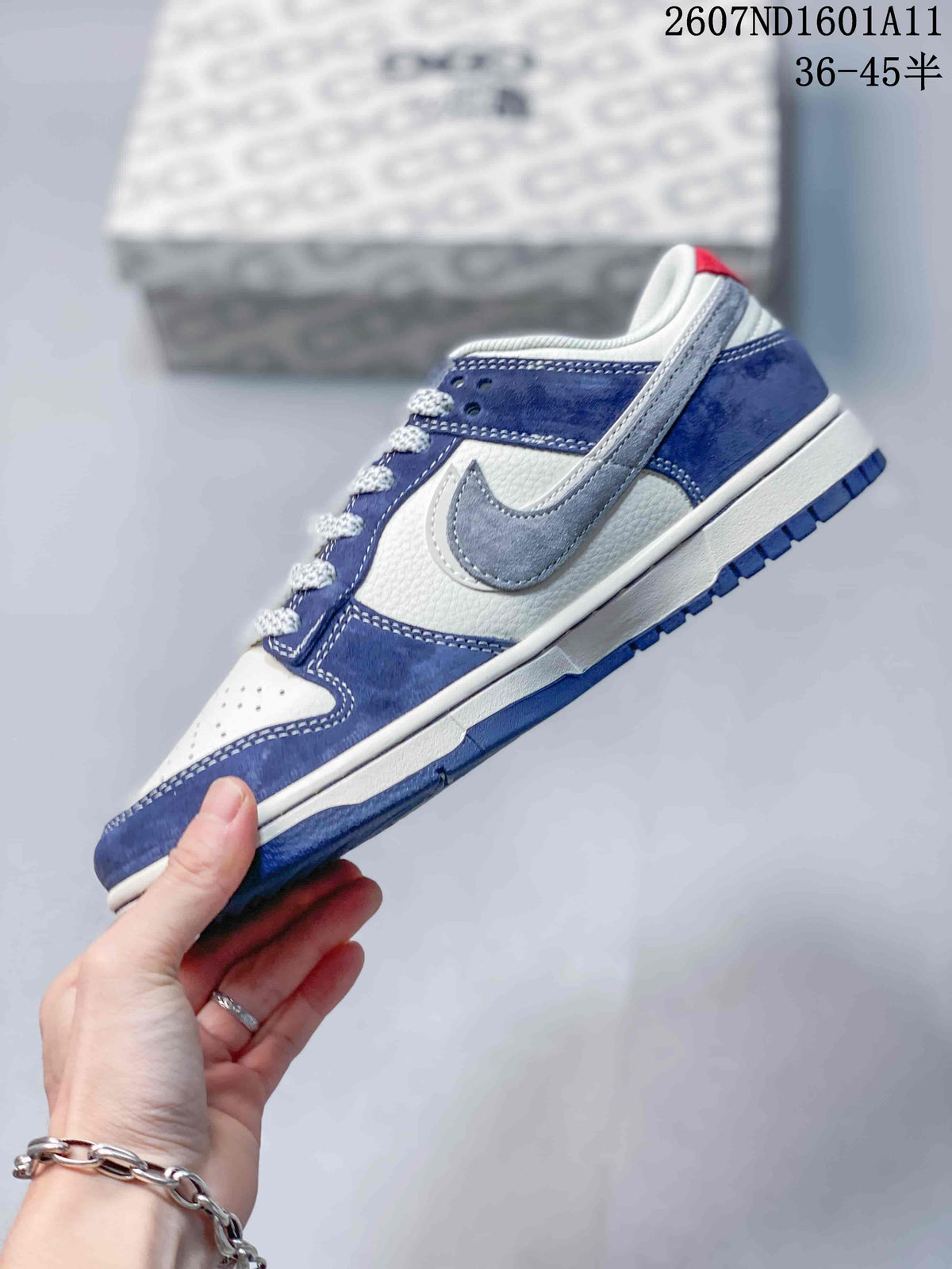 Side profile showing blue and white panels, gray swoosh-style overlay, white midsole, and blue outsole.