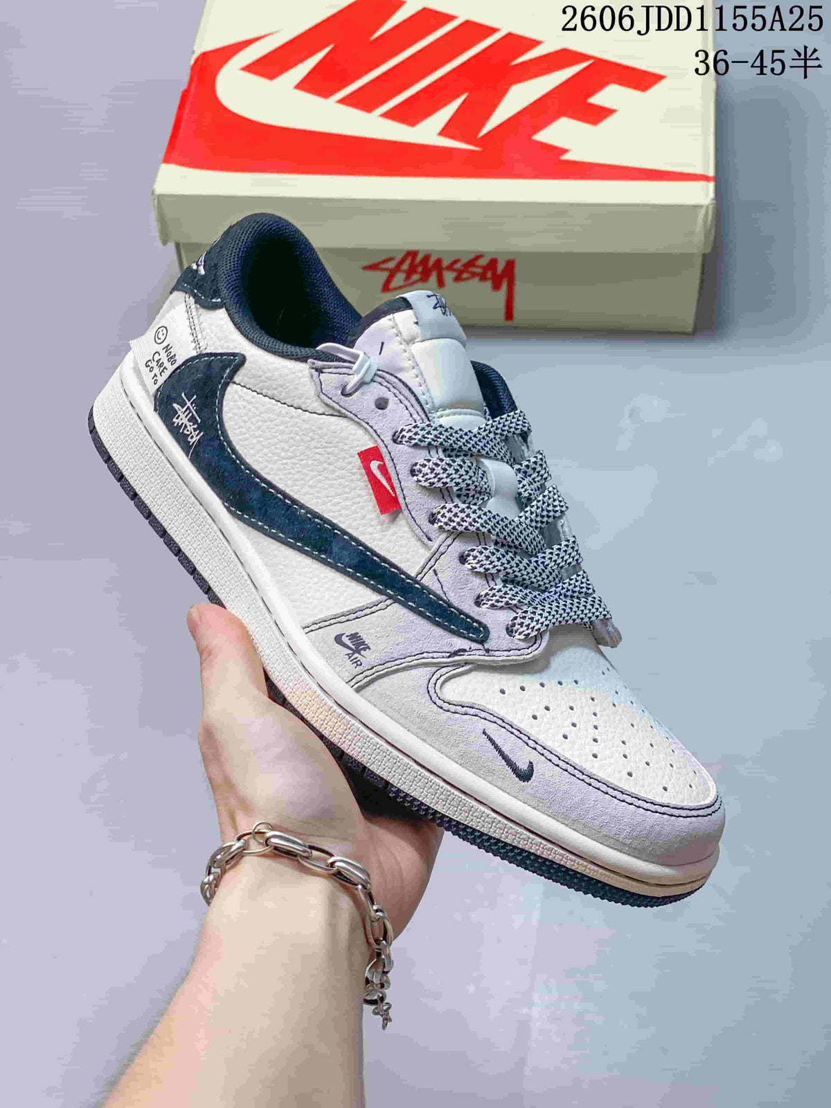 Side view of a white low-top sneaker with dark blue overlays and contrasting details