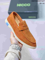 Angled close-up of a brown ECCO loafer showing the slip-on opening, penny strap, stitched toe, and light-colored sole.