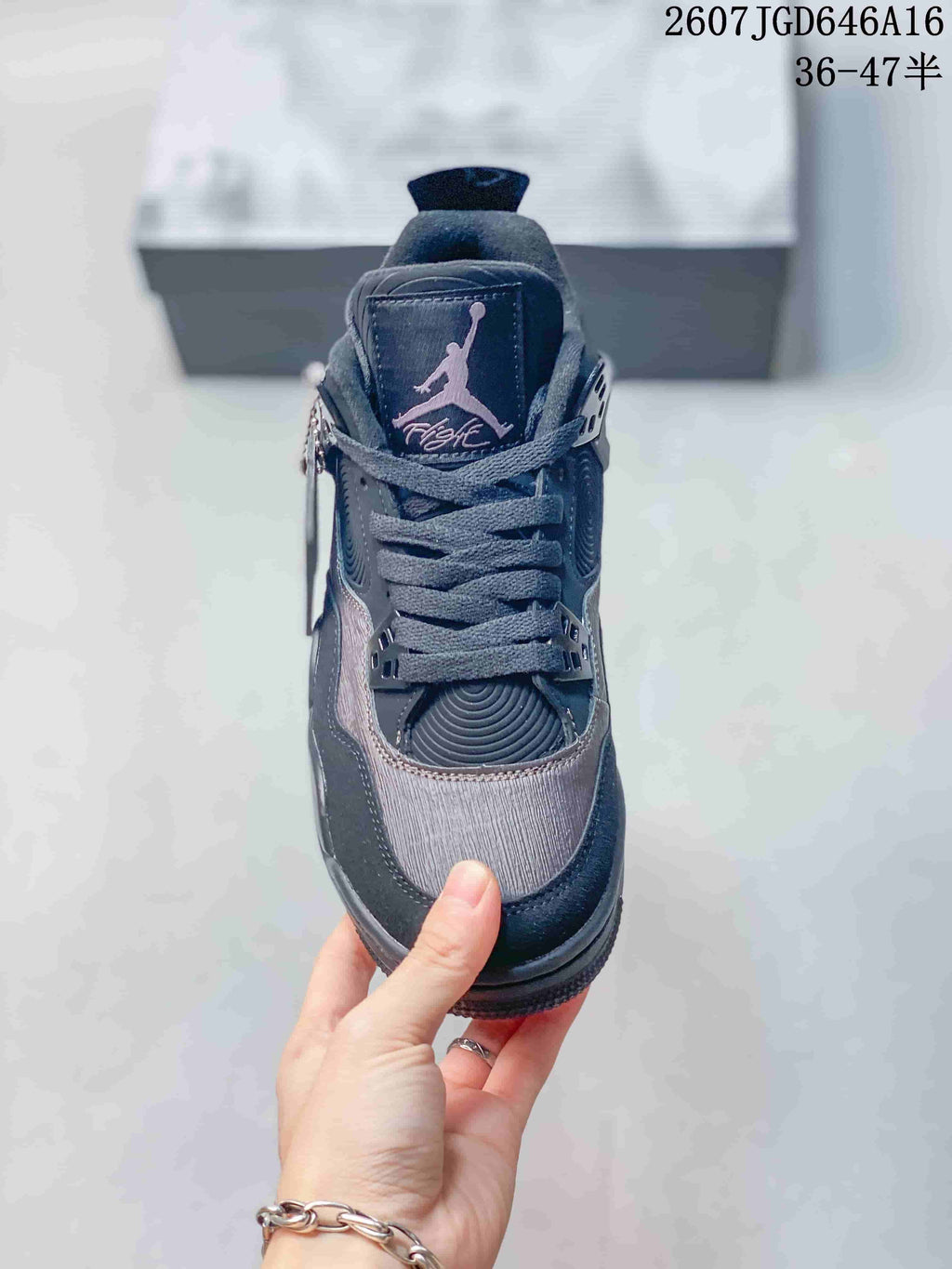 Top view showing the tongue branding, laces, textured toe panel, and black trim.