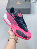 Close-up view of a black and bright pink Jordan Triangle basketball shoe with a mesh side panel and contrasting outsole.