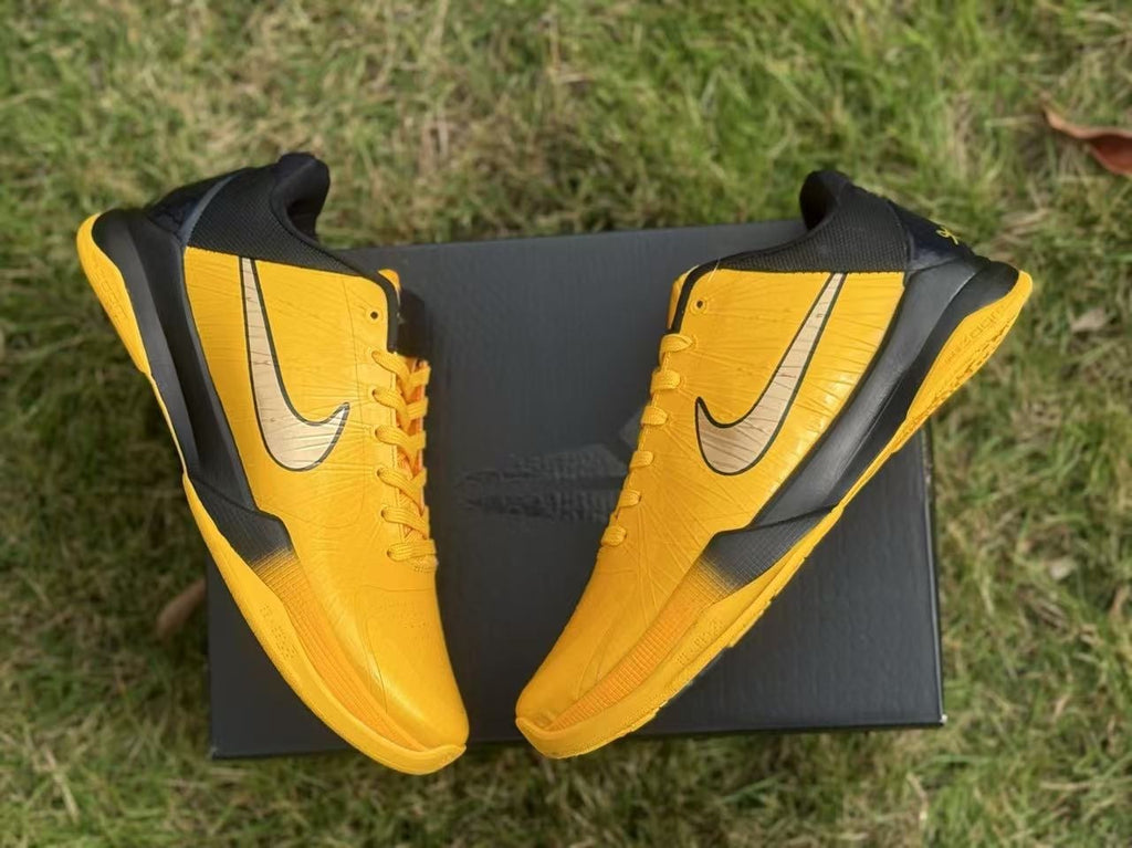 Overhead view of the yellow and black shoes arranged on a box.