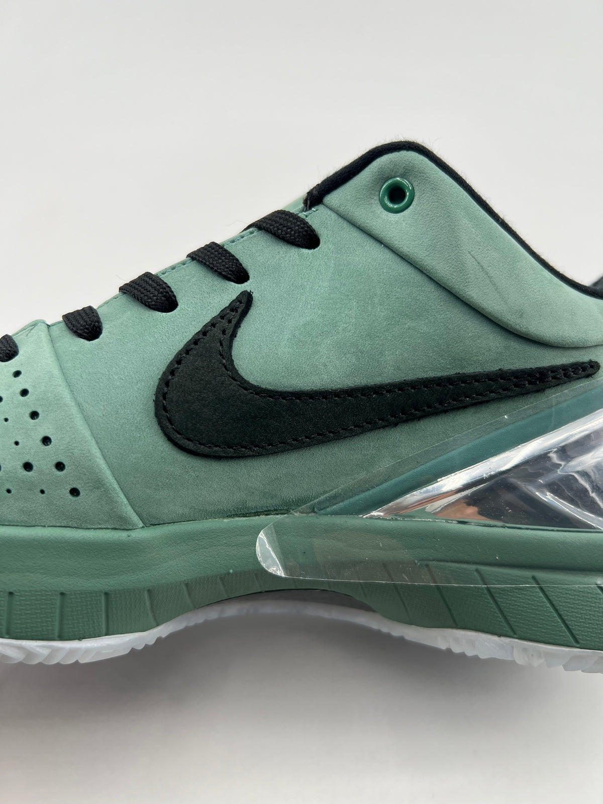 Close-up of the green side panels, black Swoosh and lace area