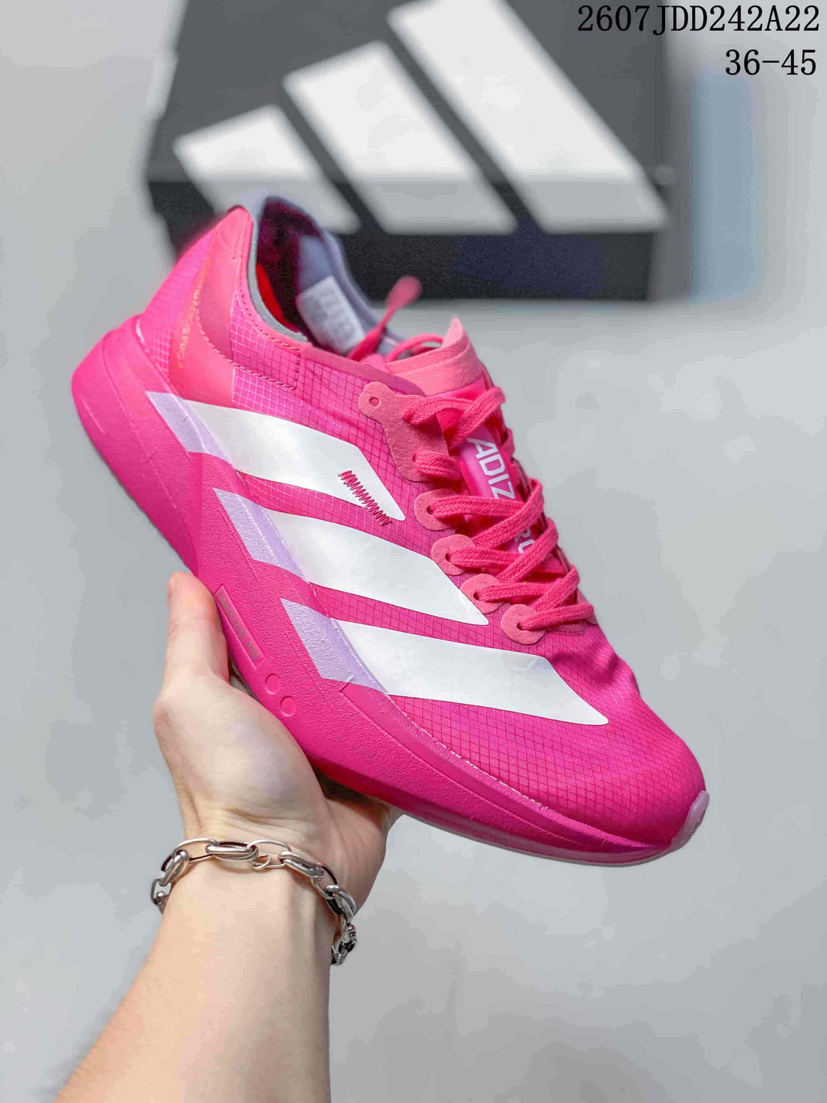 Bright pink Y-3 Adios Pro 4 sneaker with white side overlays; image text shows JDD242A22 and sizes 36–45.