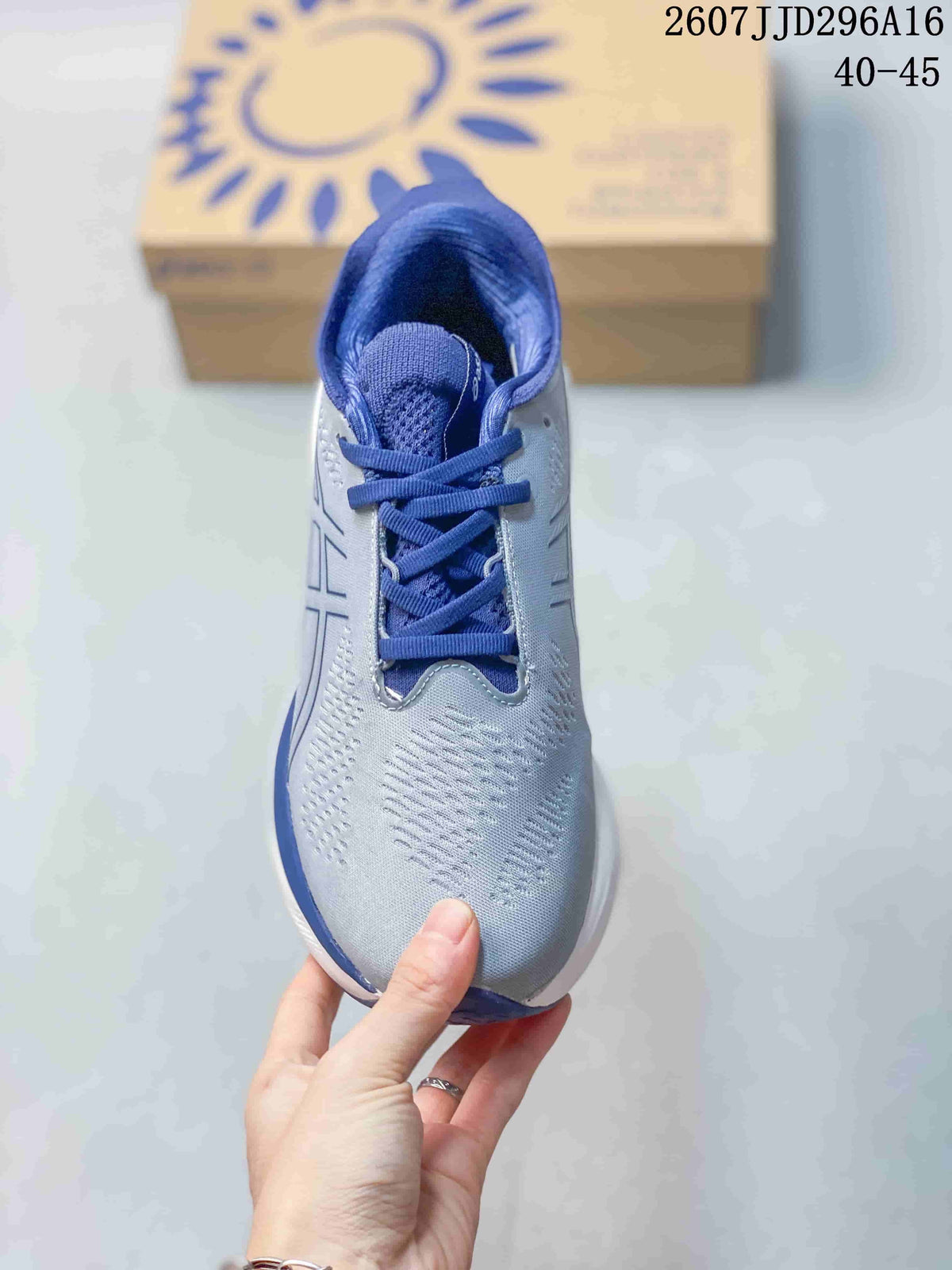 Top view showing the blue laces, padded tongue, and textured gray toe box.