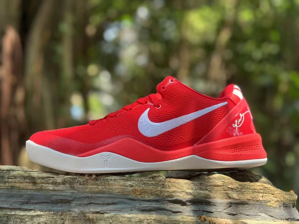 Side view of red Nike Kobe 8 basketball shoes with white side logo and outsole