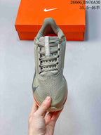 Front view showing the mesh-patterned toe, laces, and olive-grey colorway.