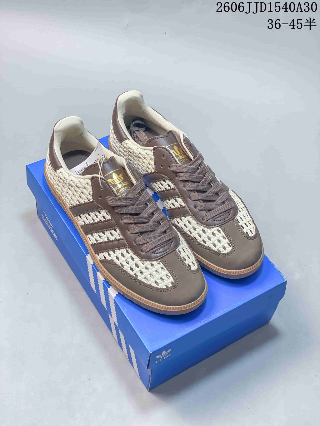 Pair of ivory and taupe-brown Adidas Originals Samba-style low-top sneakers with woven-look panels and gum-colored soles