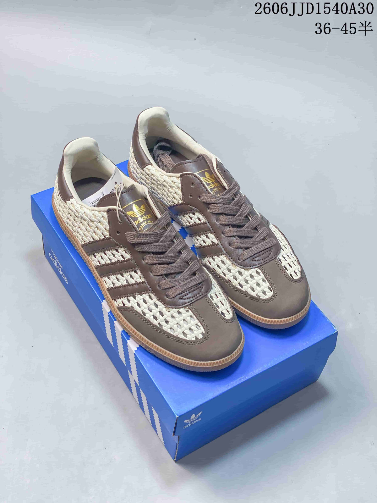 Pair of ivory and taupe-brown Adidas Originals Samba-style low-top sneakers with woven-look panels and gum-colored soles