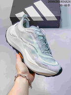 Angled side view showing the shoe's light gray and pale blue colorway