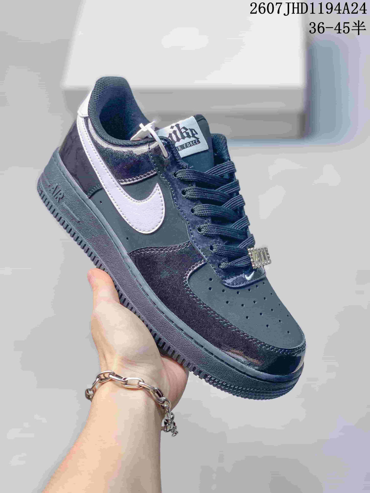 Angled side view of the black and white low-top sneaker showing the Swoosh, padded collar and layered upper.