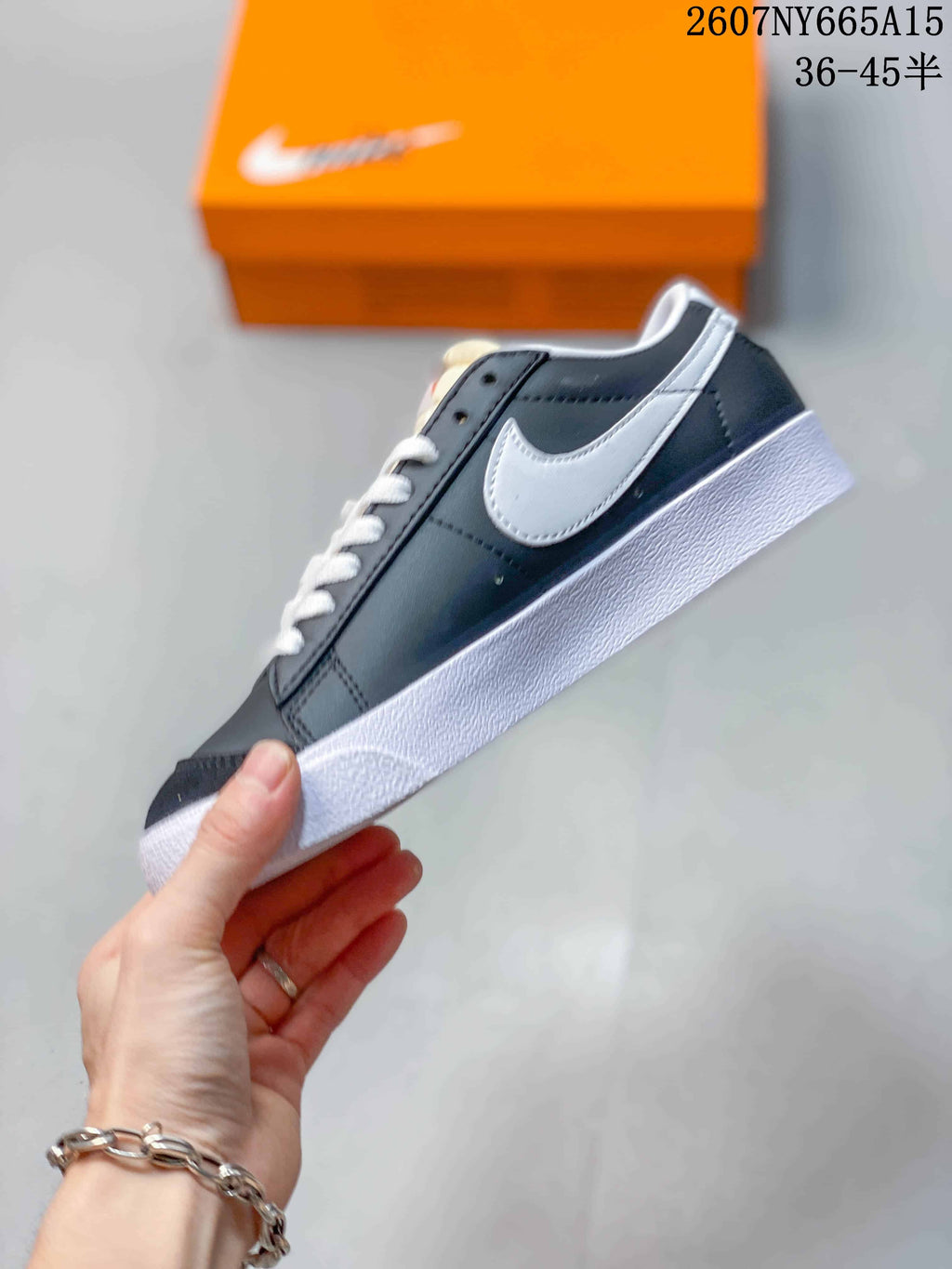 Side profile showing the black upper, white Swoosh, white laces, and white midsole.