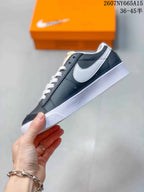 Side profile showing the black upper, white Swoosh, white laces, and white midsole.