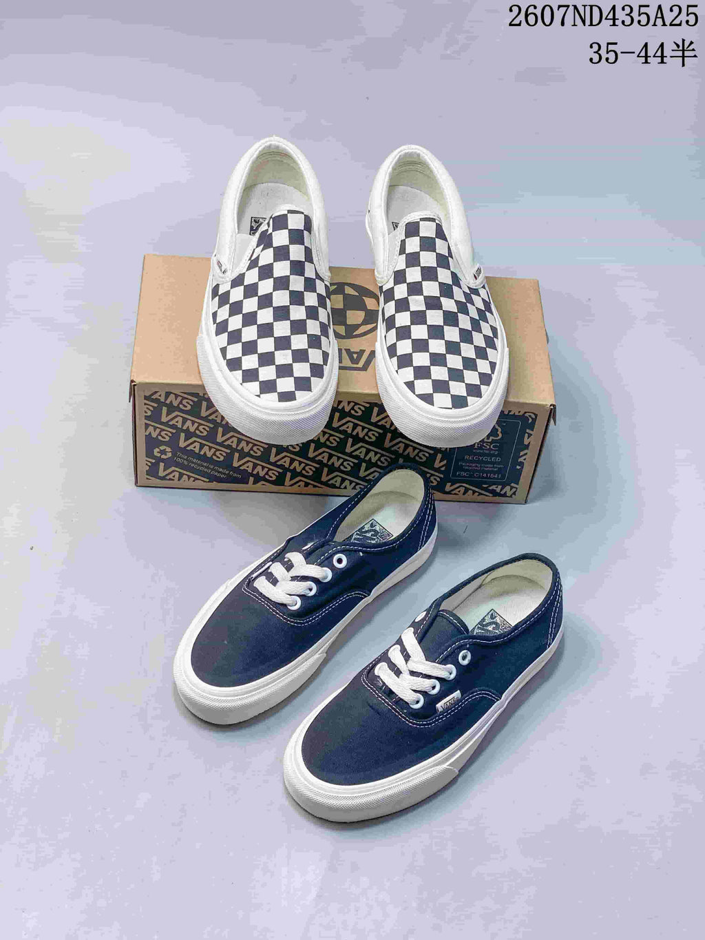 Navy lace-up sneakers and navy-and-white checkerboard slip-on sneakers displayed together with Vans boxes.