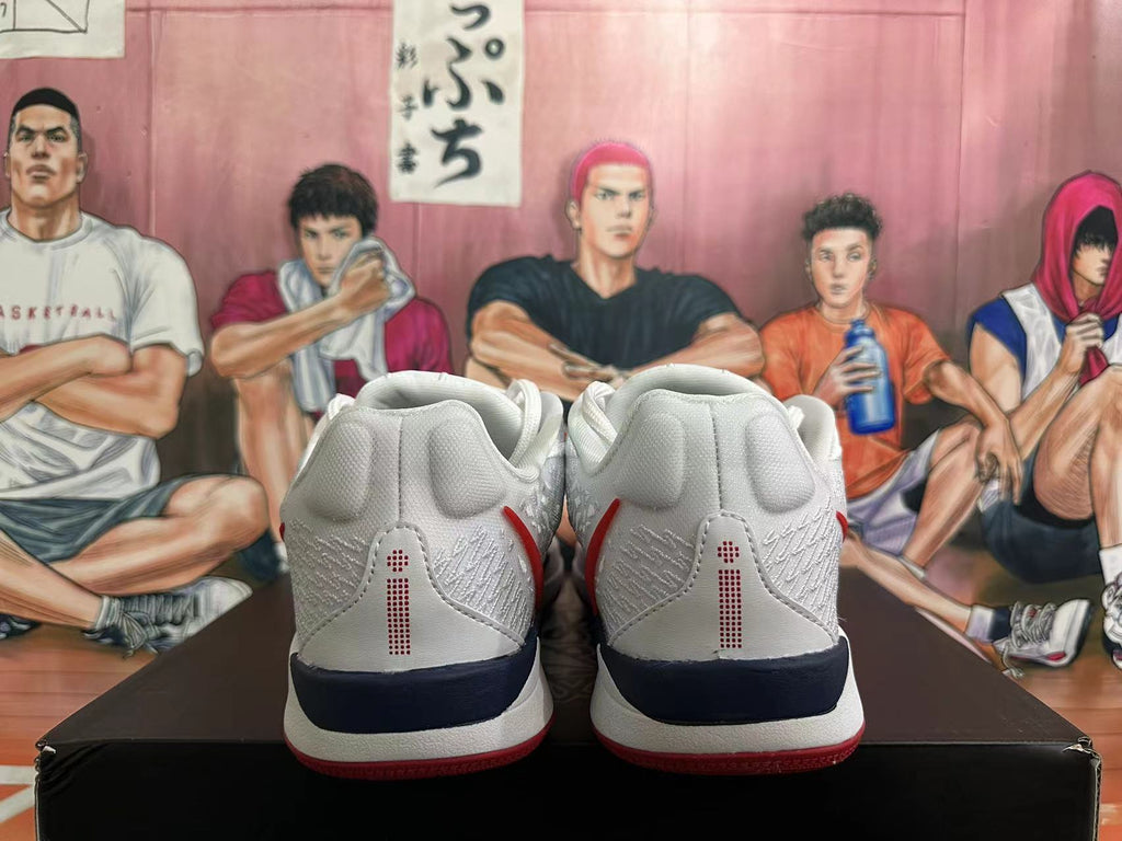 Rear view of the white basketball shoes showing textured panels and navy heel accents.