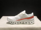 Side profile of one white sneaker with a coral-red stripe and structured outsole.