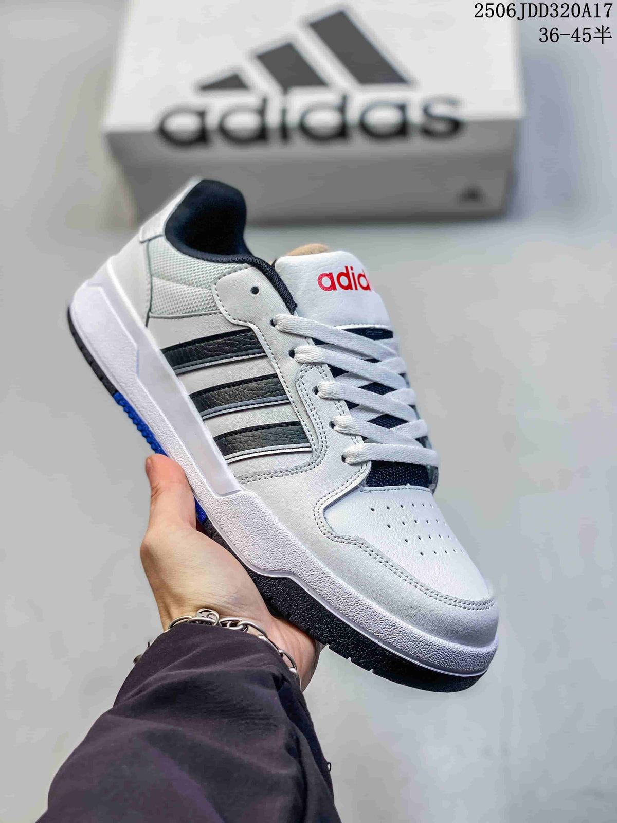 White adidas Entrap sneaker with black side stripes, red tongue branding and a dark outsole.