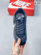 Top view of a dark Nike Classic Cortez sneaker with lace-up fastening