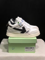 Side view of the white sneakers showing the black arrow detail, layered panels, and textured outsole.