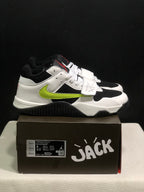 Side view showing the white upper, black panels, fluorescent green side detail, and black outsole.