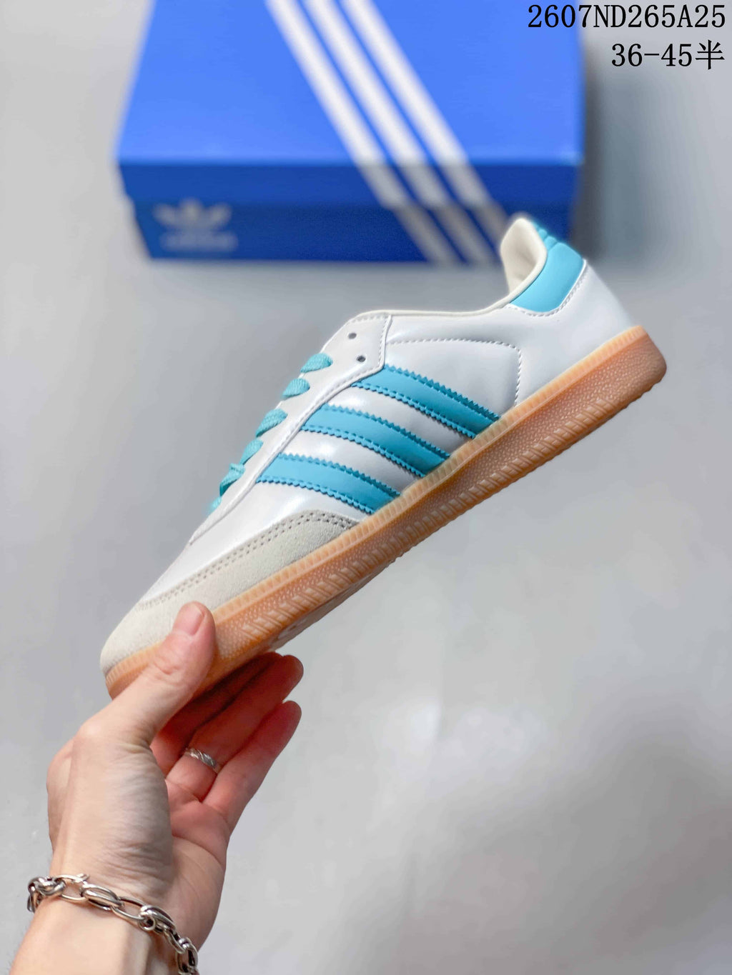 Side view highlighting the blue three-stripe panels, white upper, and gum-colored sole.