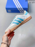 Side view highlighting the blue three-stripe panels, white upper, and gum-colored sole.