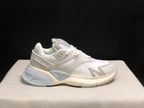 Close side profile of a white and light grey AMIRI MA Runner sneaker.