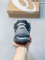 Rear view of the black and silver sneaker showing the Gel-Nimbus 10.1 heel label, silver heel panel, and layered sole.