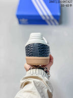 Rear view of the sneaker showing the dark woven-texture heel, white padded collar, and gum-colored sole.
