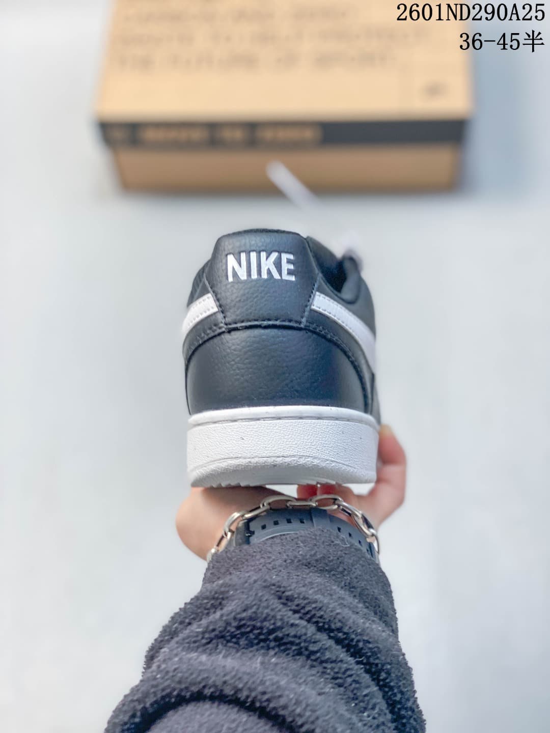 Rear view of the navy sneaker with white Swoosh detailing and a white sole.