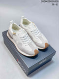 White and navy ECCO lace-up sneakers shown together from the front, with gum-colored toe details.