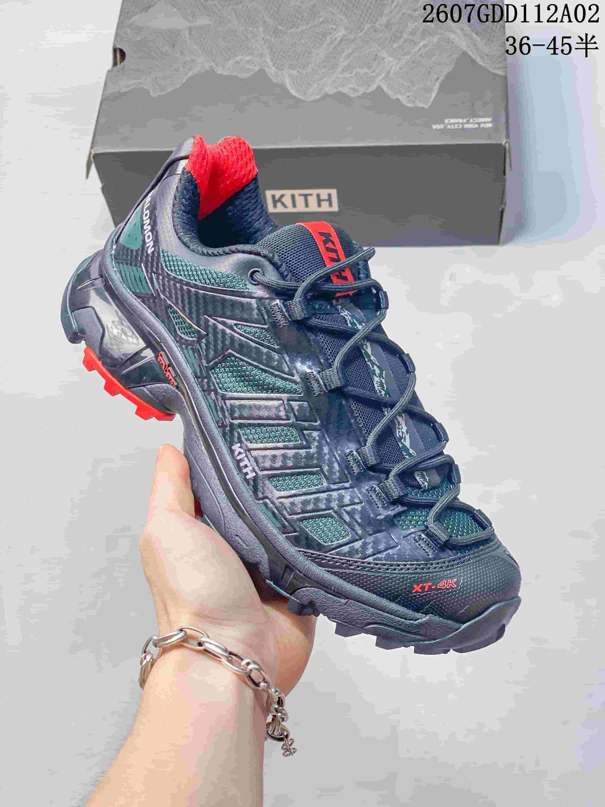 Side view of a dark navy Salomon XT-4K sneaker with a quick-lace system.