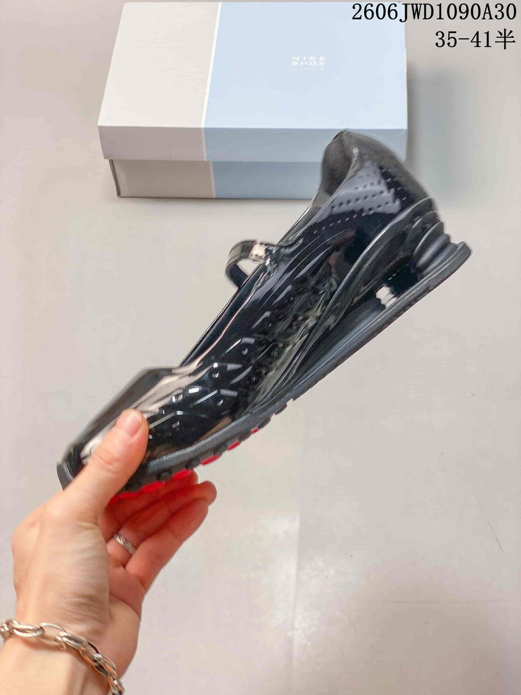 Side view highlighting the glossy upper and sculpted sole