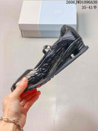 Side view highlighting the glossy upper and sculpted sole