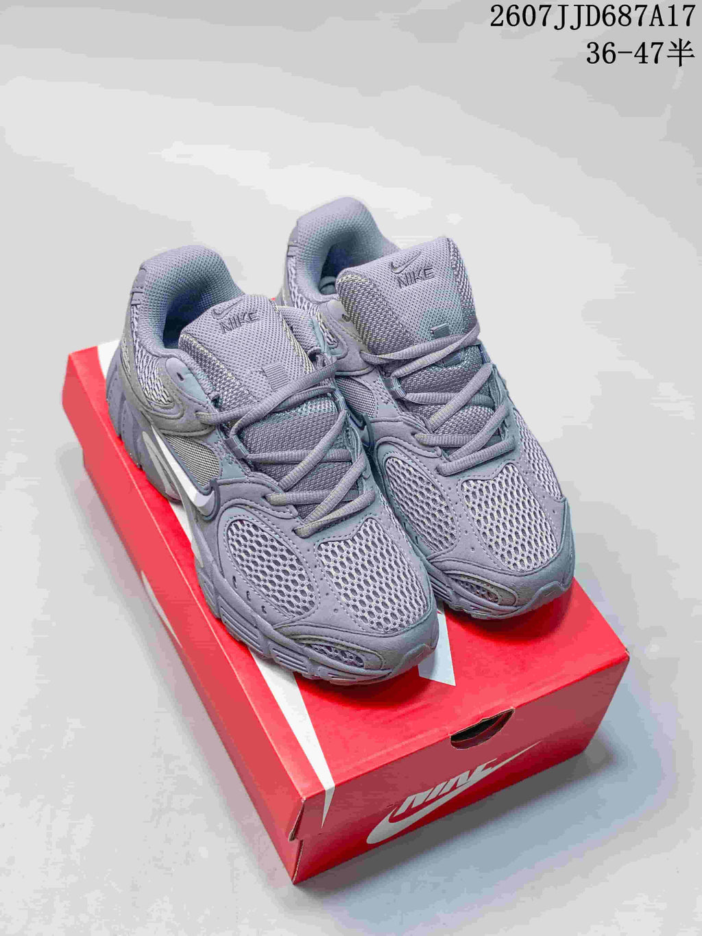 Gray Nike V5 RNR sneakers shown from the front on a red shoe box, with the style code and size range visible above.