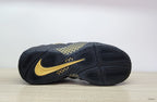 Outsole view showing black tread and gold detailing on the Nike Air Foamposite Pro