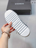 Underside of a white sneaker showing the ridged rubber outsole and NUMERIS branding.