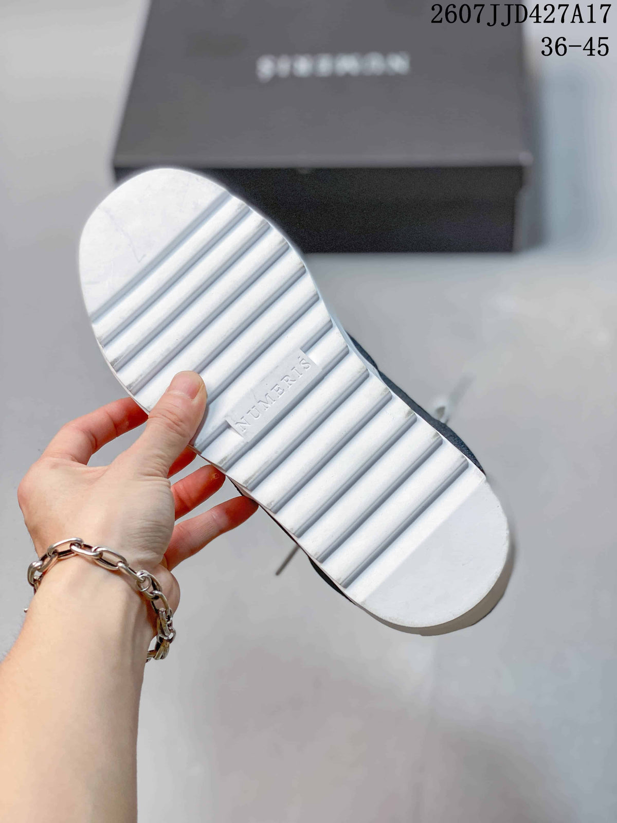 Underside of a white sneaker showing the ridged rubber outsole and NUMERIS branding.