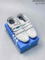 White adidas Originals ANFU Mary Jane shoes with three straps, shown on a blue box.