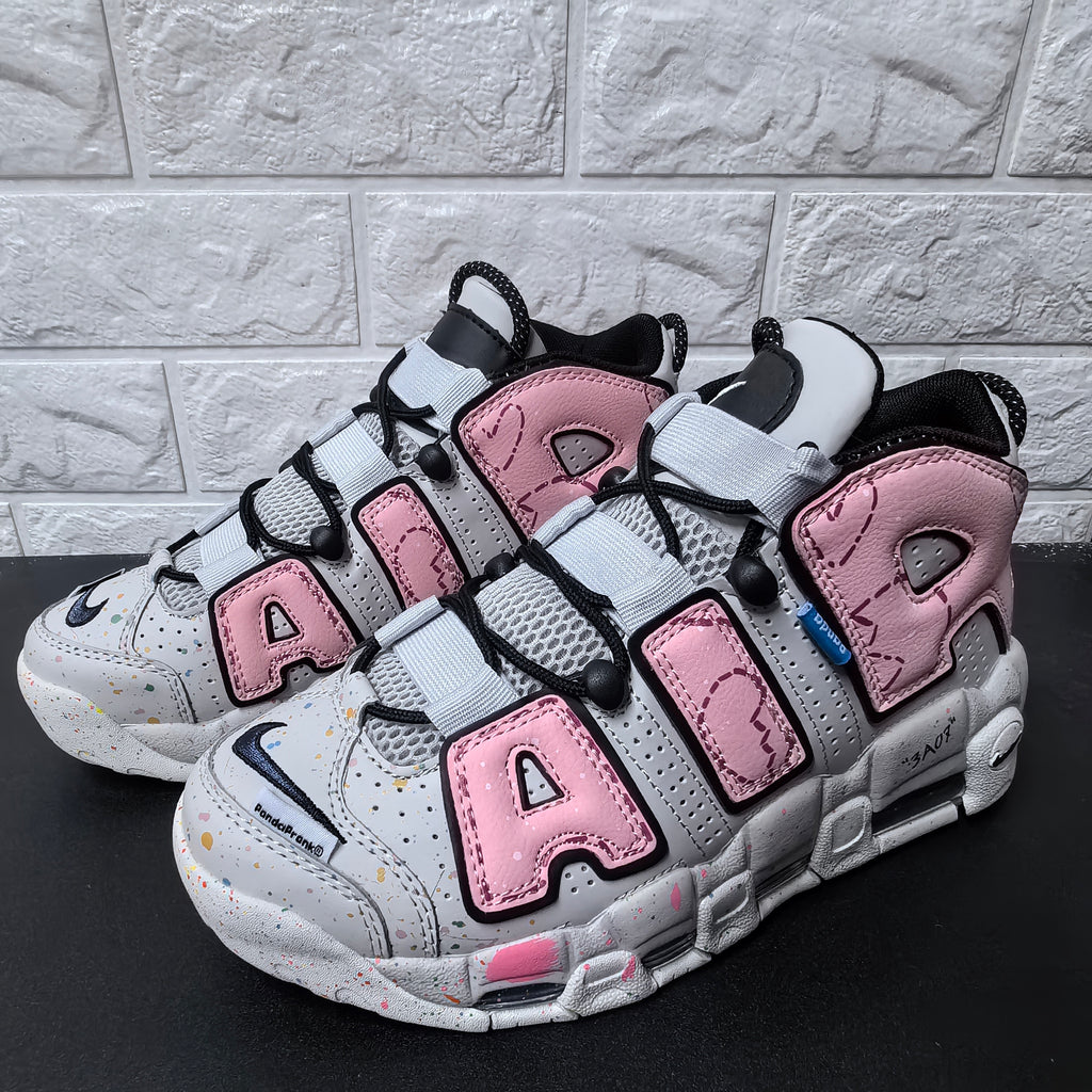 Pair of pink and grey sneakers with prominent AIR lettering and black laces
