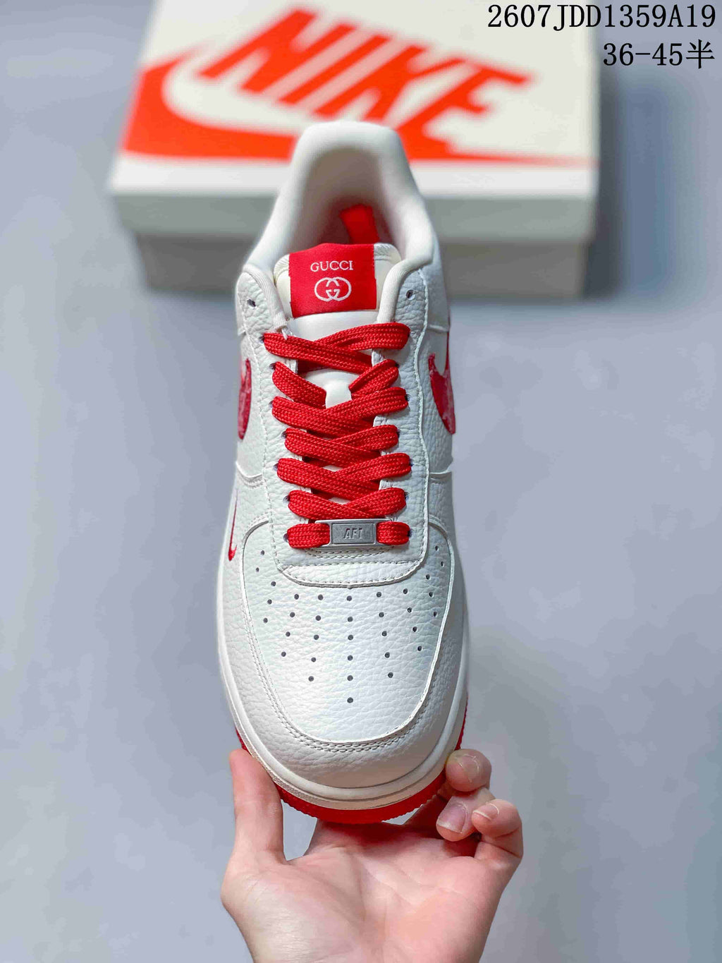 Top view of the sneaker showing red laces, perforated toe box, and red tongue branding.