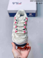 Top view of the sneaker showing the layered toe panel, white laces, pink lace loops, and gray patterned detailing.