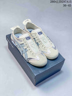 Pair of cream and pale blue Onitsuka Tiger sneakers displayed on a branded shoe box; style code 2604JJD297A15 and size range 36-45 are visible.