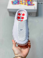 Top view of a white Nike Mind 001 slide showing the textured front panel and slip-on opening.