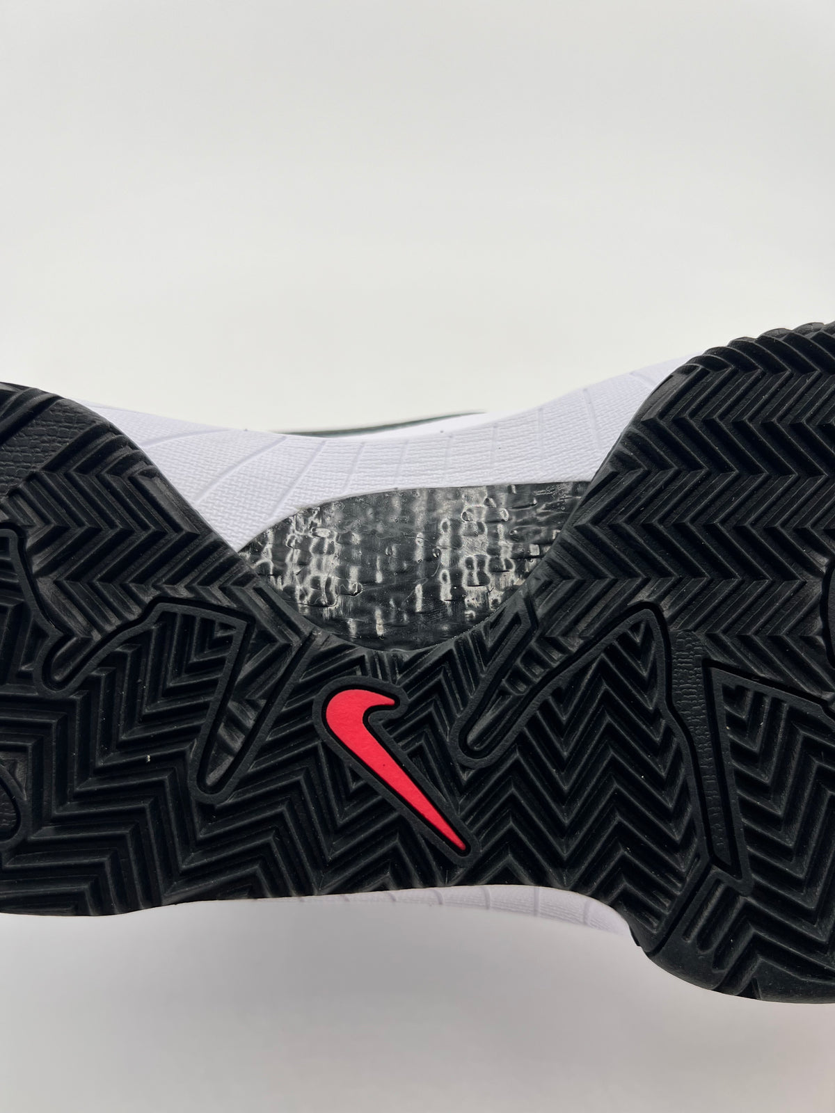 Close-up of the black herringbone outsole with red Swoosh detail