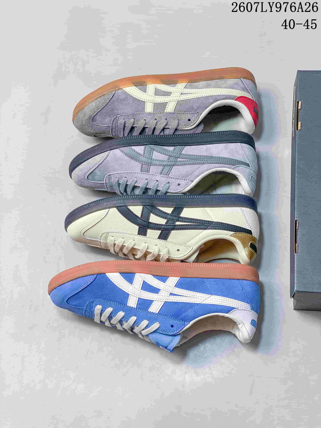 Top-down view showing four Onitsuka Tiger Tokuten colorways arranged beside a shoebox.