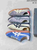 Top-down view showing four Onitsuka Tiger Tokuten colorways arranged beside a shoebox.