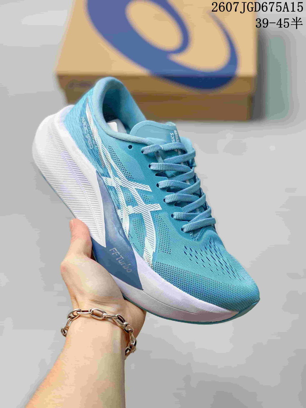 Blue and white ASICS Magic Speed 4 running shoe with a pale blue textile upper and contrasting white logo.